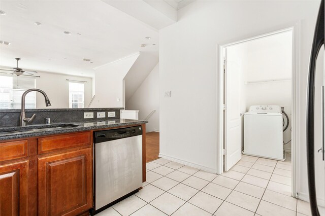 kitchen featuring sink, dark stone countertops, crown molding, light hardwood / wood-style floors, and appliances with stainless steel finishes