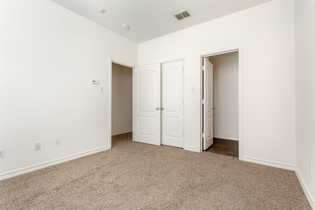 unfurnished bedroom with a closet and carpet