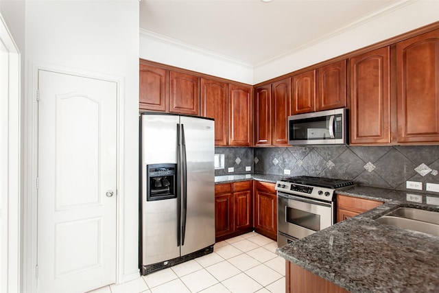 kitchen with sink, stainless steel appliances, washer / clothes dryer, light tile patterned flooring, and ornamental molding