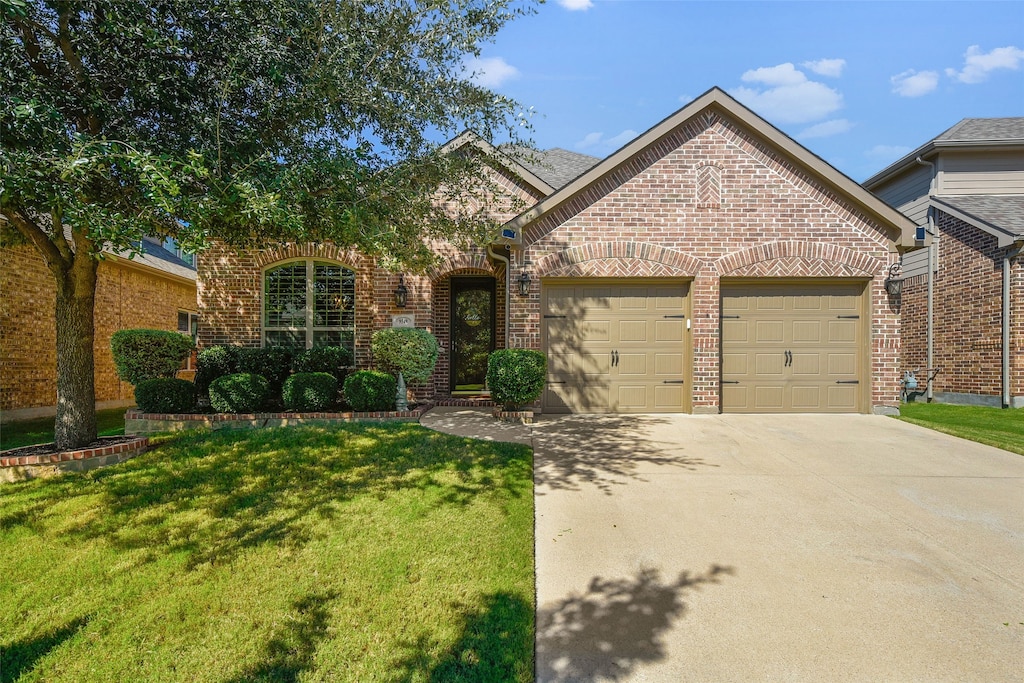 view of front of house with a garage and a front lawn