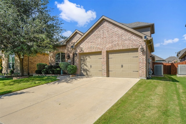 front of property with a garage, a front lawn, and central air condition unit