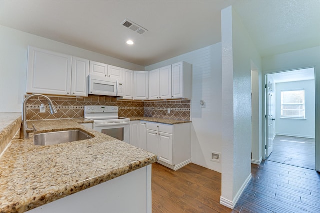 kitchen featuring white cabinetry, sink, white appliances, and light hardwood / wood-style flooring