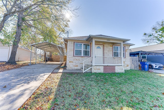 view of front of home with a carport, a porch, and a front yard