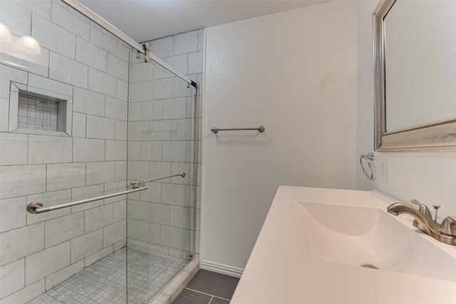 bathroom featuring tile patterned floors, sink, and a shower with door