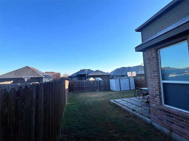 view of yard featuring a storage shed and a patio