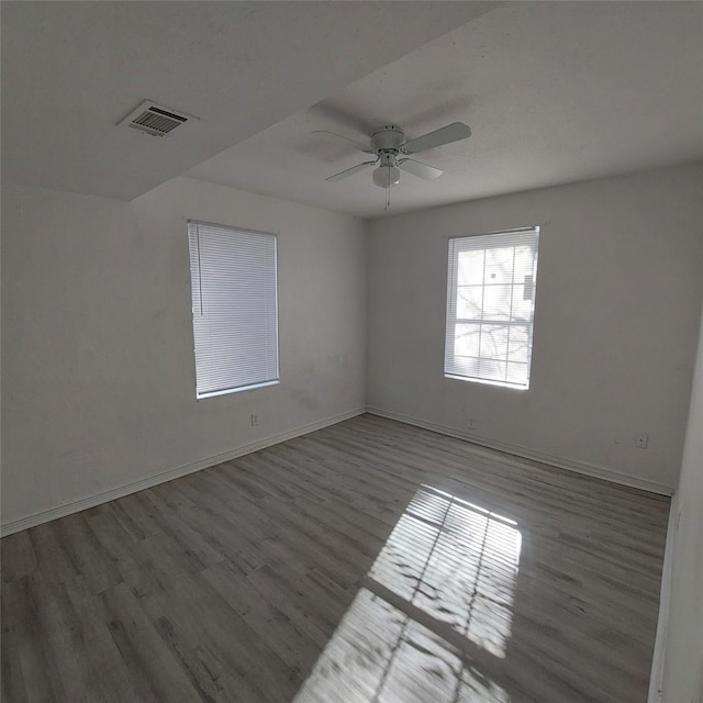 spare room featuring hardwood / wood-style floors and ceiling fan