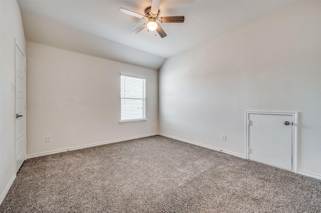 empty room with ceiling fan, carpet floors, and vaulted ceiling