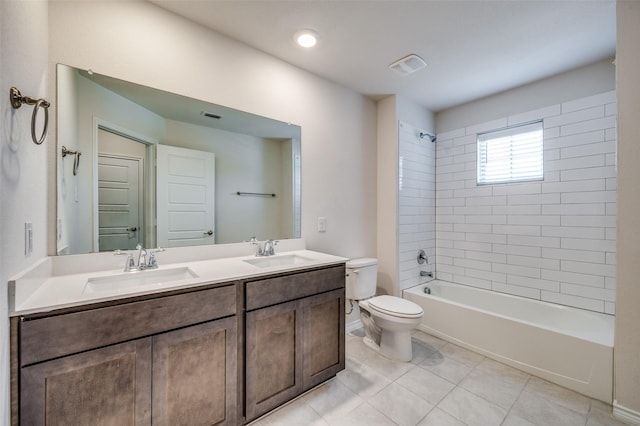 full bathroom with tile patterned floors, tiled shower / bath combo, toilet, and vanity