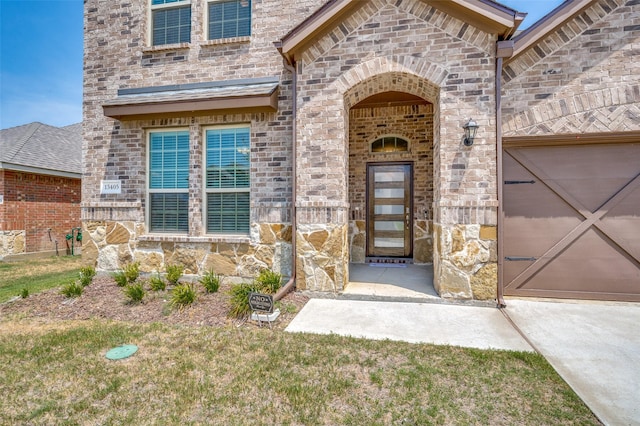 entrance to property featuring brick siding and a garage