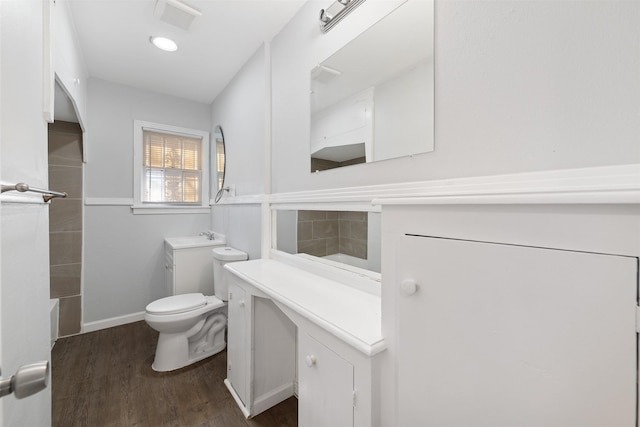 full bathroom with hardwood / wood-style flooring, vanity, toilet, and bathtub / shower combination