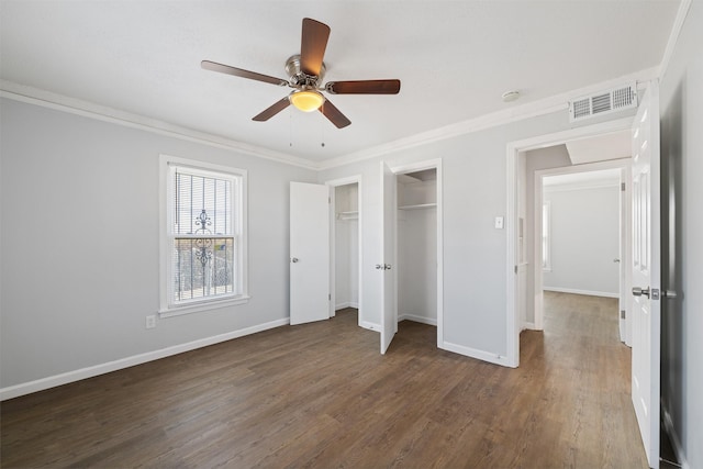 unfurnished bedroom featuring ceiling fan, dark hardwood / wood-style flooring, and ornamental molding