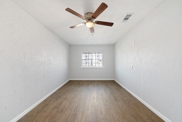 spare room featuring hardwood / wood-style flooring and ceiling fan