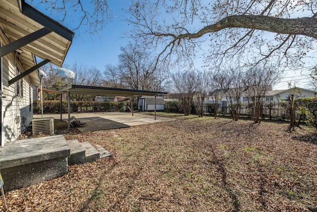 view of yard with a patio area, cooling unit, and a storage unit