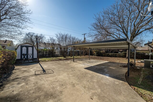 view of patio / terrace with central AC unit, a shed, and a carport