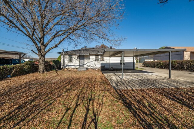 rear view of property with a carport