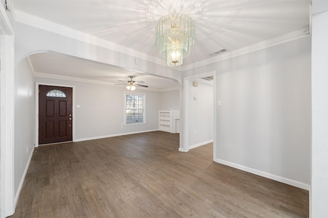 foyer entrance with wood-type flooring, ceiling fan with notable chandelier, and ornamental molding