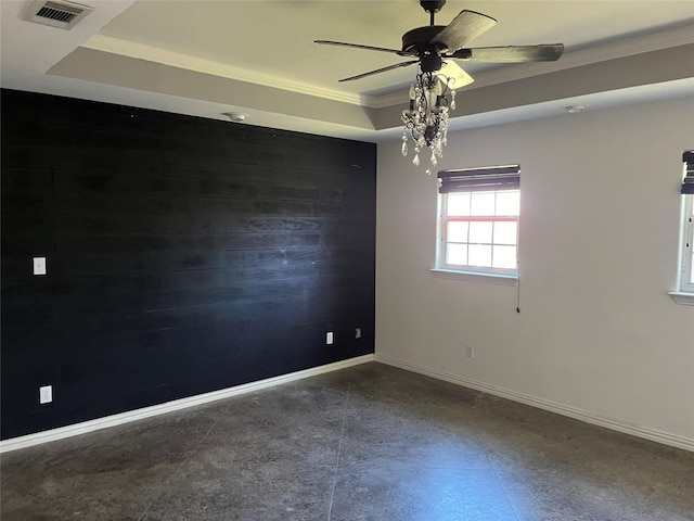 spare room featuring a raised ceiling, ceiling fan, and crown molding