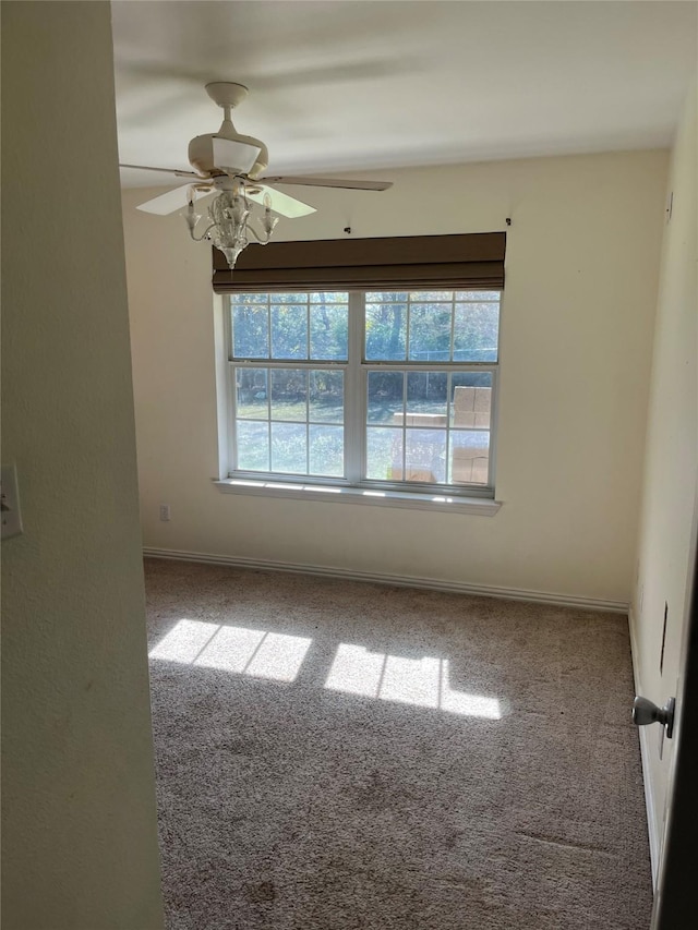 carpeted empty room with ceiling fan