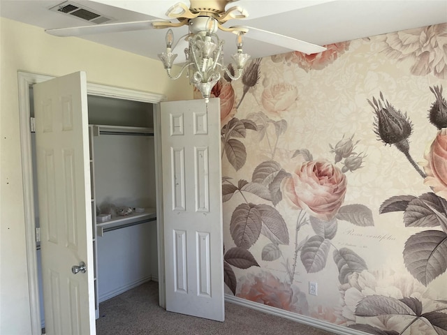 carpeted bedroom with ceiling fan and a closet