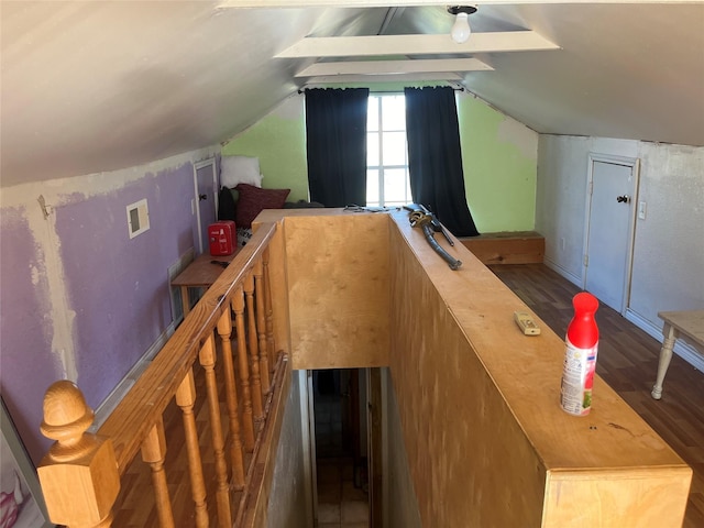 additional living space featuring wood-type flooring and vaulted ceiling