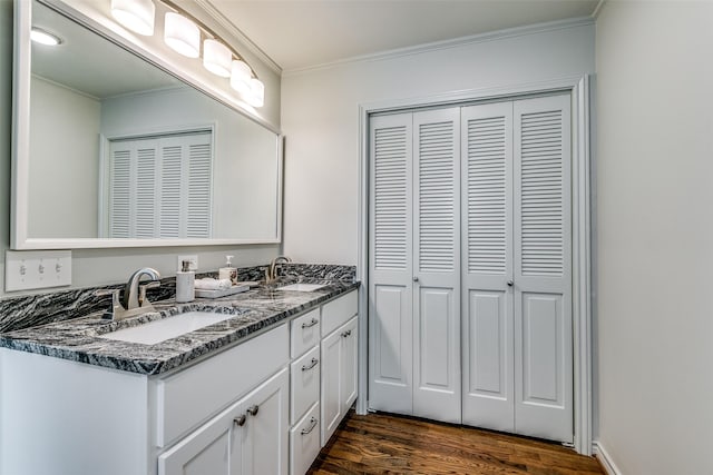 bathroom featuring hardwood / wood-style flooring, vanity, and ornamental molding