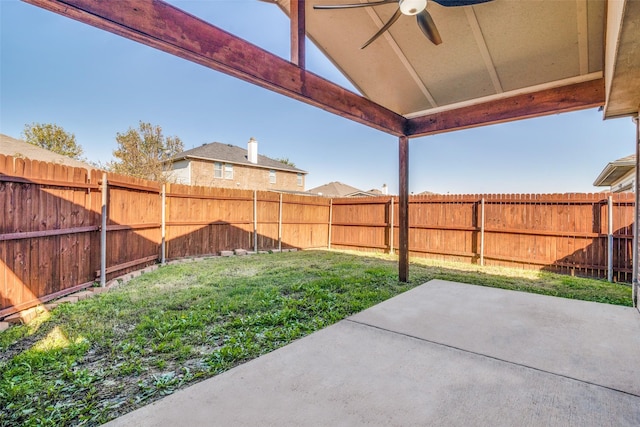 view of yard with ceiling fan and a patio