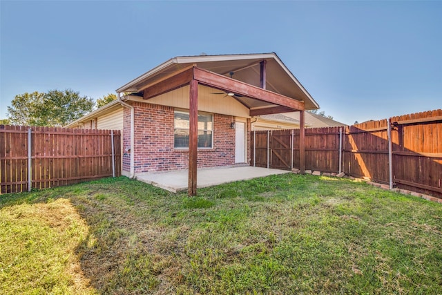 back of house with a lawn, ceiling fan, and a patio