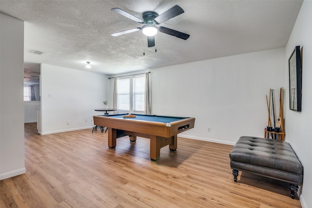 recreation room with ceiling fan, light hardwood / wood-style floors, a textured ceiling, and pool table