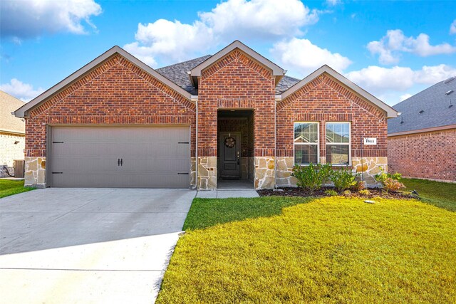 view of front property with cooling unit, a garage, and a front lawn