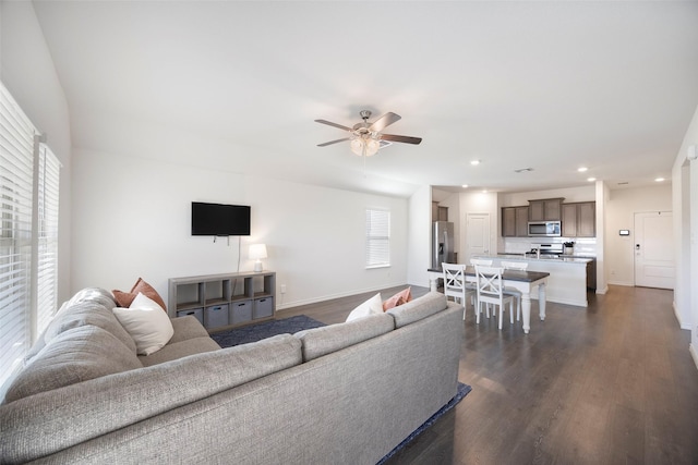 living room with baseboards, dark wood-type flooring, a ceiling fan, and recessed lighting