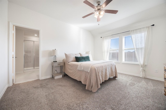 carpeted bedroom with a ceiling fan, lofted ceiling, baseboards, and ensuite bathroom