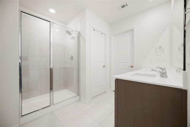 full bathroom featuring tile patterned flooring, vanity, visible vents, and a shower stall