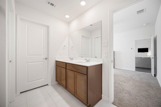 bathroom with double vanity, tile patterned flooring, a sink, and visible vents