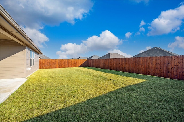 view of yard with a fenced backyard