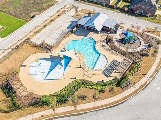 view of swimming pool featuring a patio area, a fenced backyard, and a water play area