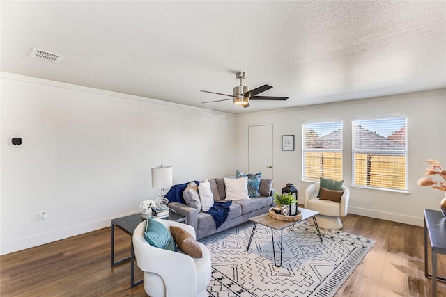 living room with visible vents, a textured ceiling, wood finished floors, baseboards, and ceiling fan