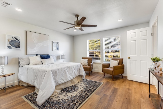 bedroom with ceiling fan and hardwood / wood-style floors