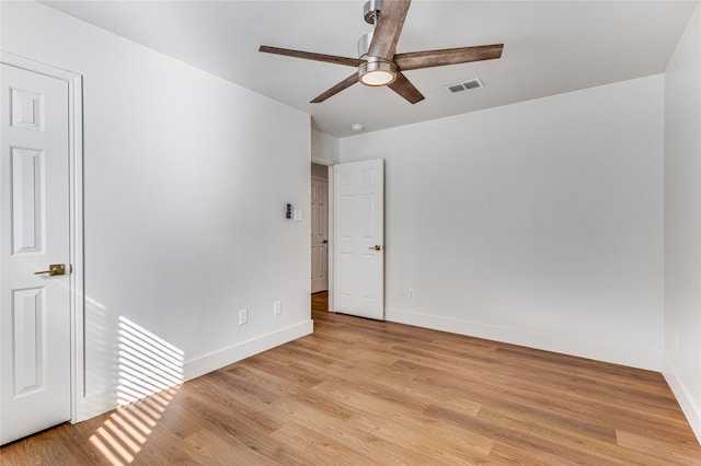 unfurnished bedroom featuring light wood finished floors, visible vents, a ceiling fan, and baseboards