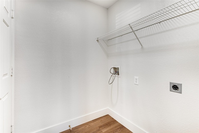 clothes washing area with baseboards, laundry area, hookup for a washing machine, wood finished floors, and electric dryer hookup