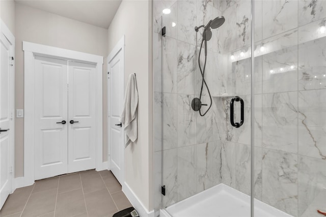 bathroom with a shower with shower door and tile patterned floors