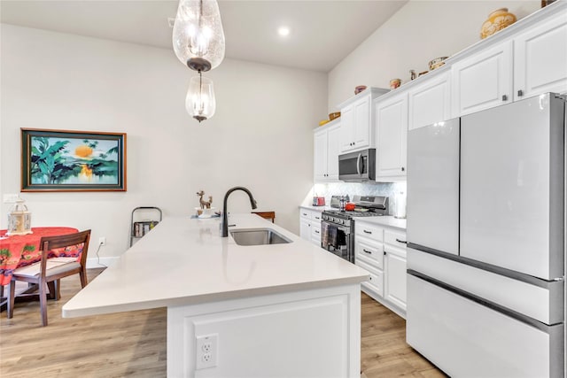 kitchen featuring sink, white cabinets, backsplash, hanging light fixtures, and stainless steel appliances