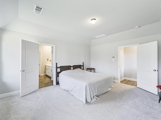 carpeted bedroom with ensuite bathroom