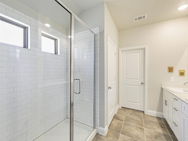 bathroom with vanity, tile patterned floors, and an enclosed shower