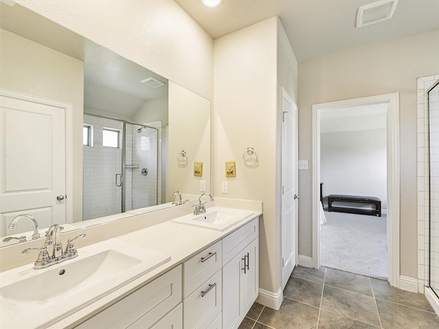 bathroom featuring vanity, tile patterned floors, and a shower with door