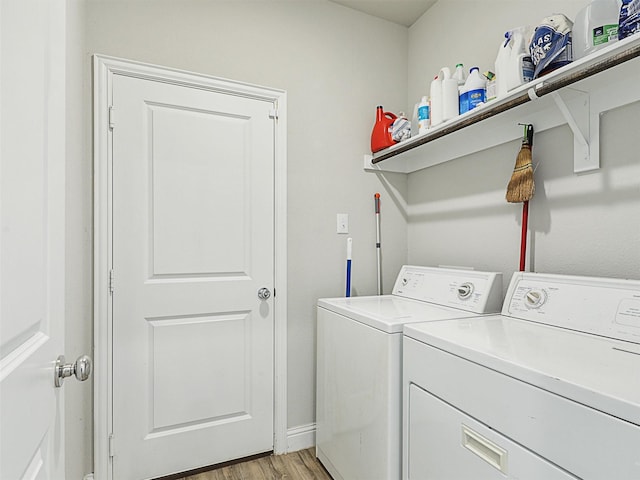 laundry room featuring light hardwood / wood-style flooring and washer and clothes dryer