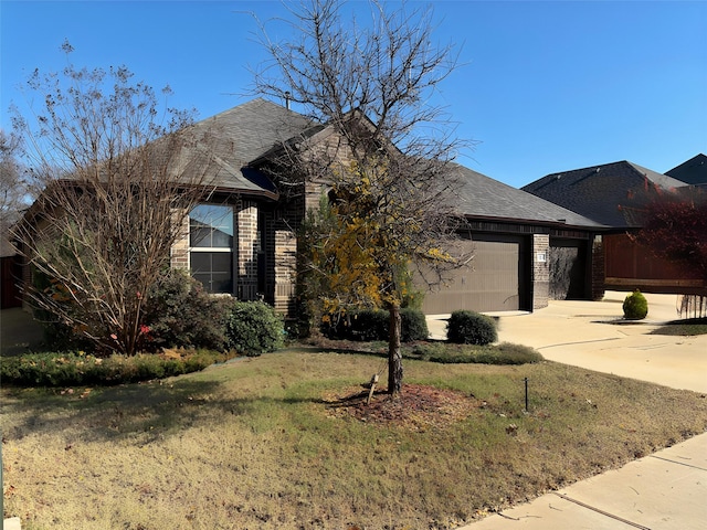 view of front of property with a garage and a front lawn