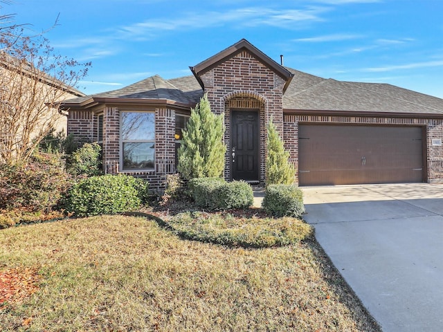 view of front of property with a front yard and a garage