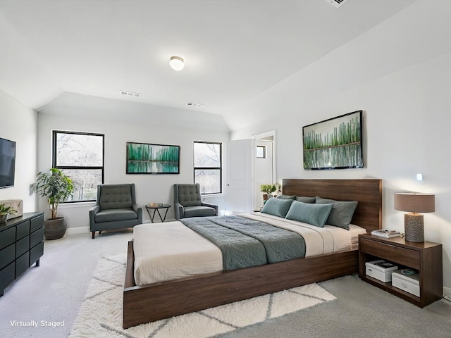 bedroom with light carpet, vaulted ceiling, and multiple windows