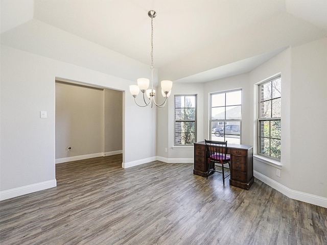 home office featuring a chandelier, dark wood-type flooring, and lofted ceiling