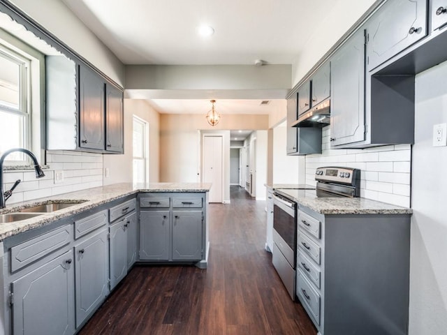 kitchen with stainless steel electric range, a healthy amount of sunlight, dark hardwood / wood-style floors, and sink